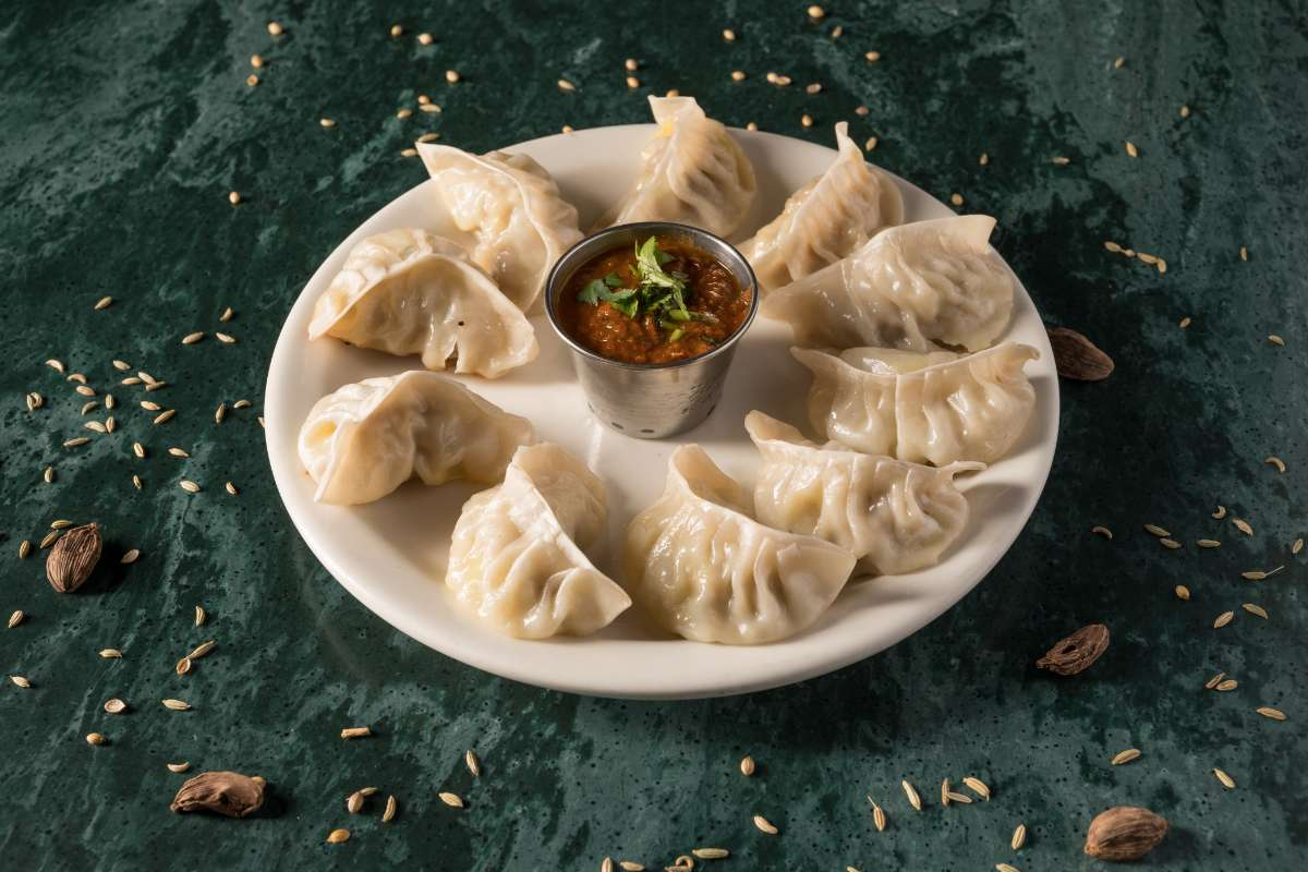 Steamed momos with dipping sauce